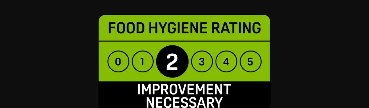 Official FHRS 2 rating badge on black — what a food hygiene rating of 2 means
