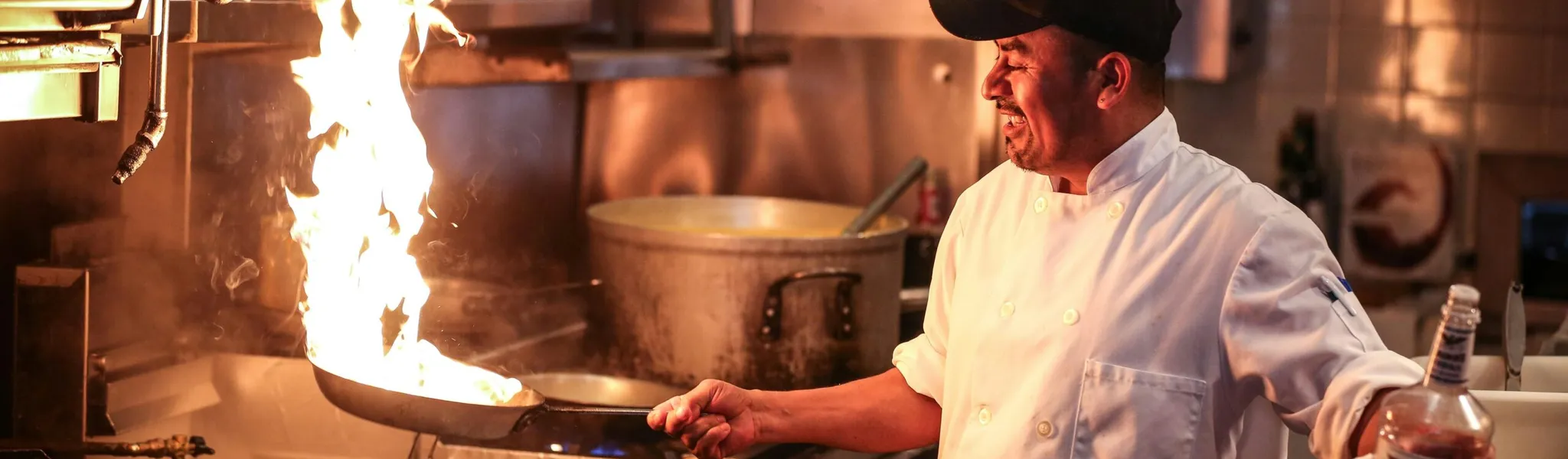 Chef using digital tablet for food temperature recording in a professional kitchen