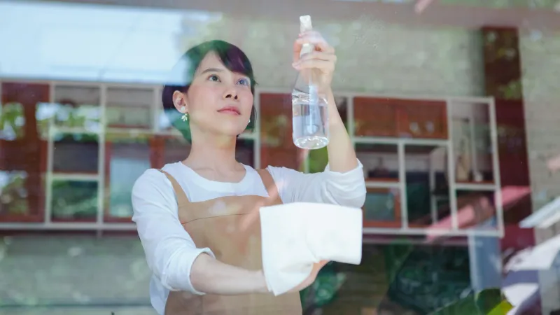 Chef performing temperature checks in commercial kitchen with digital thermometer