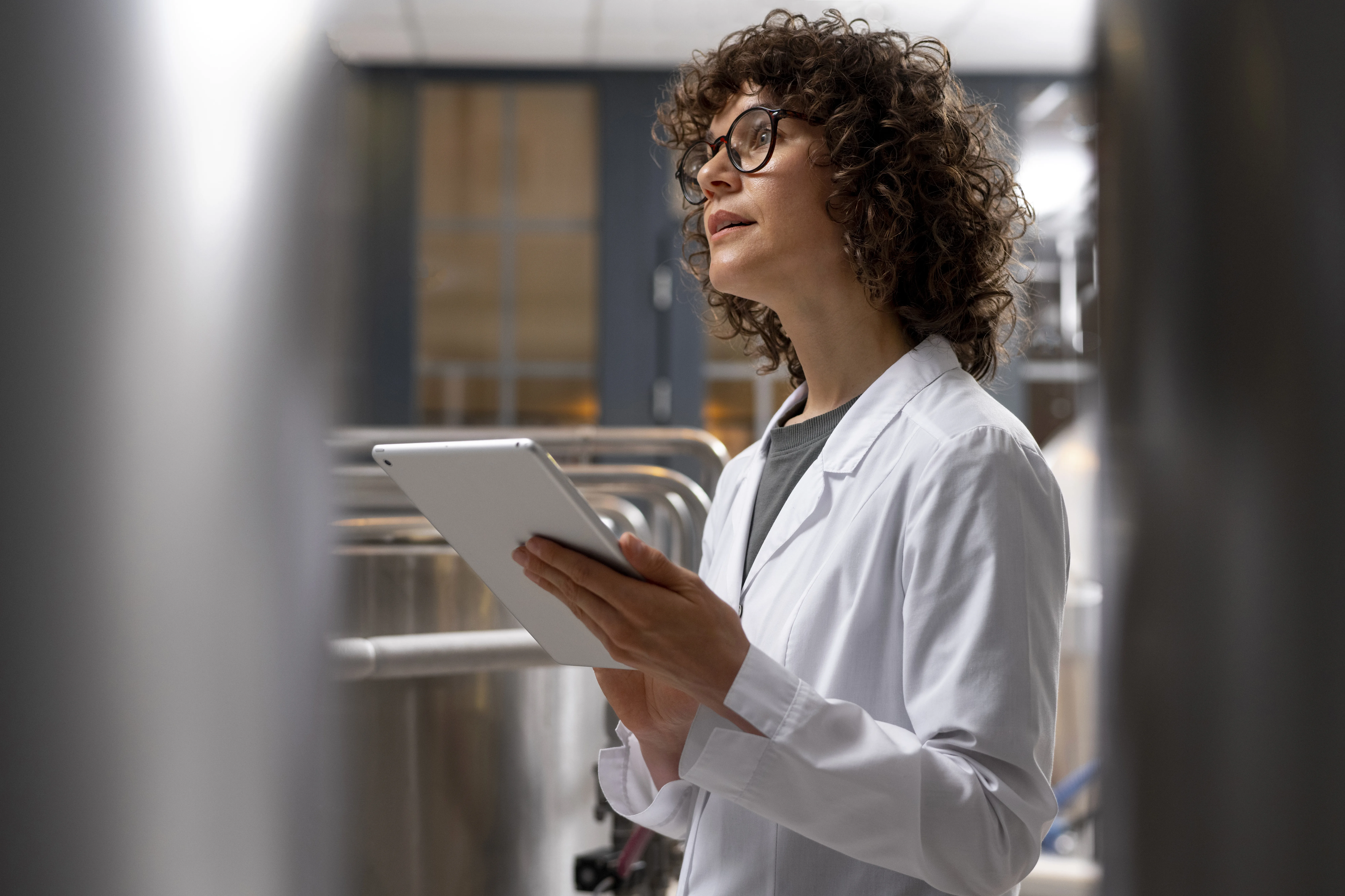 Food business manager reviewing safety documentation in commercial kitchen